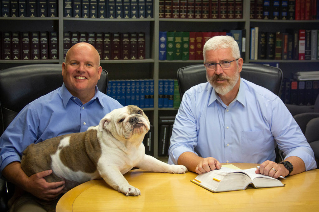 Brumback and Ottem sitting with Mo the Bulldog