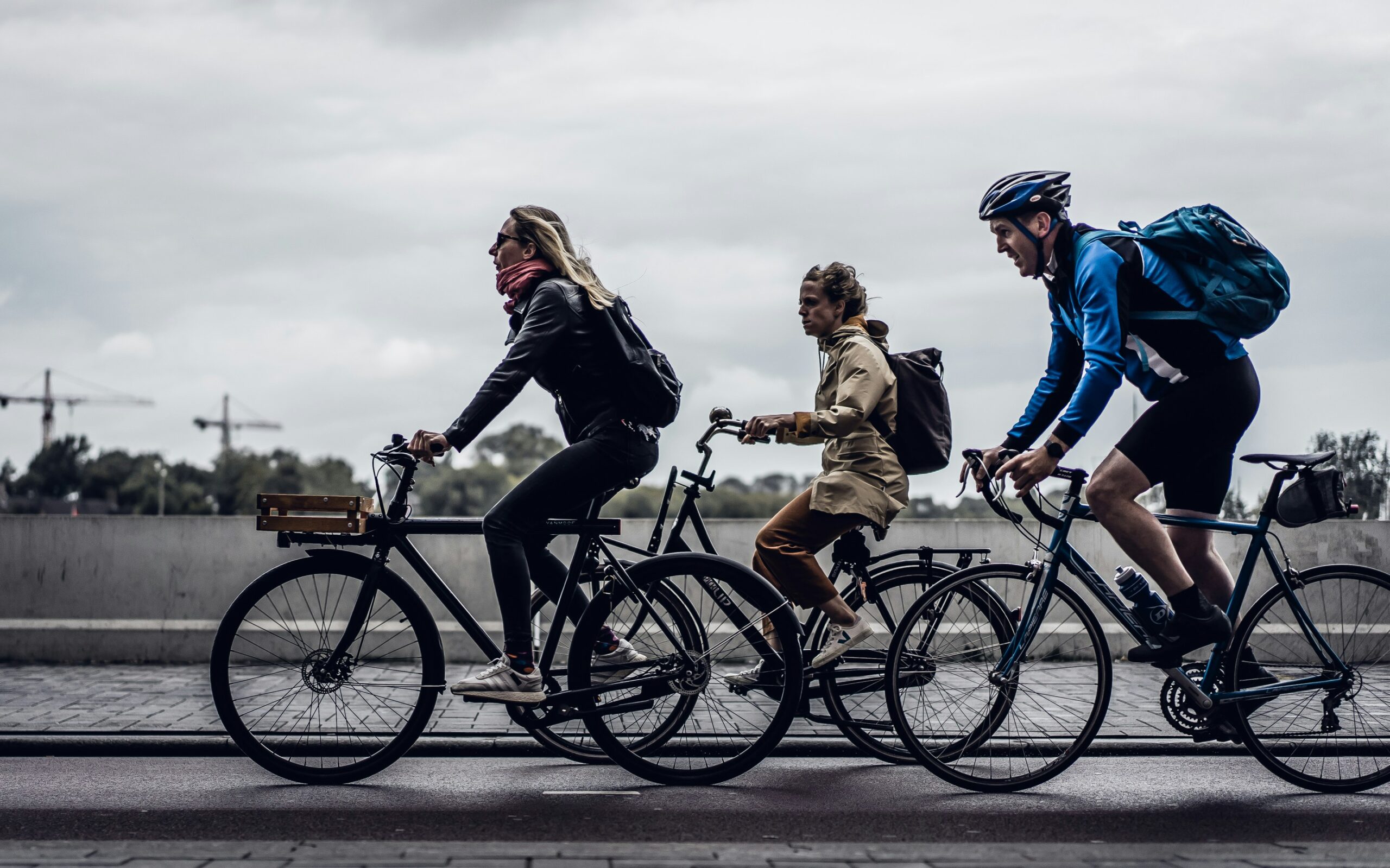 three-adults-riding-bicycles-in-the-city